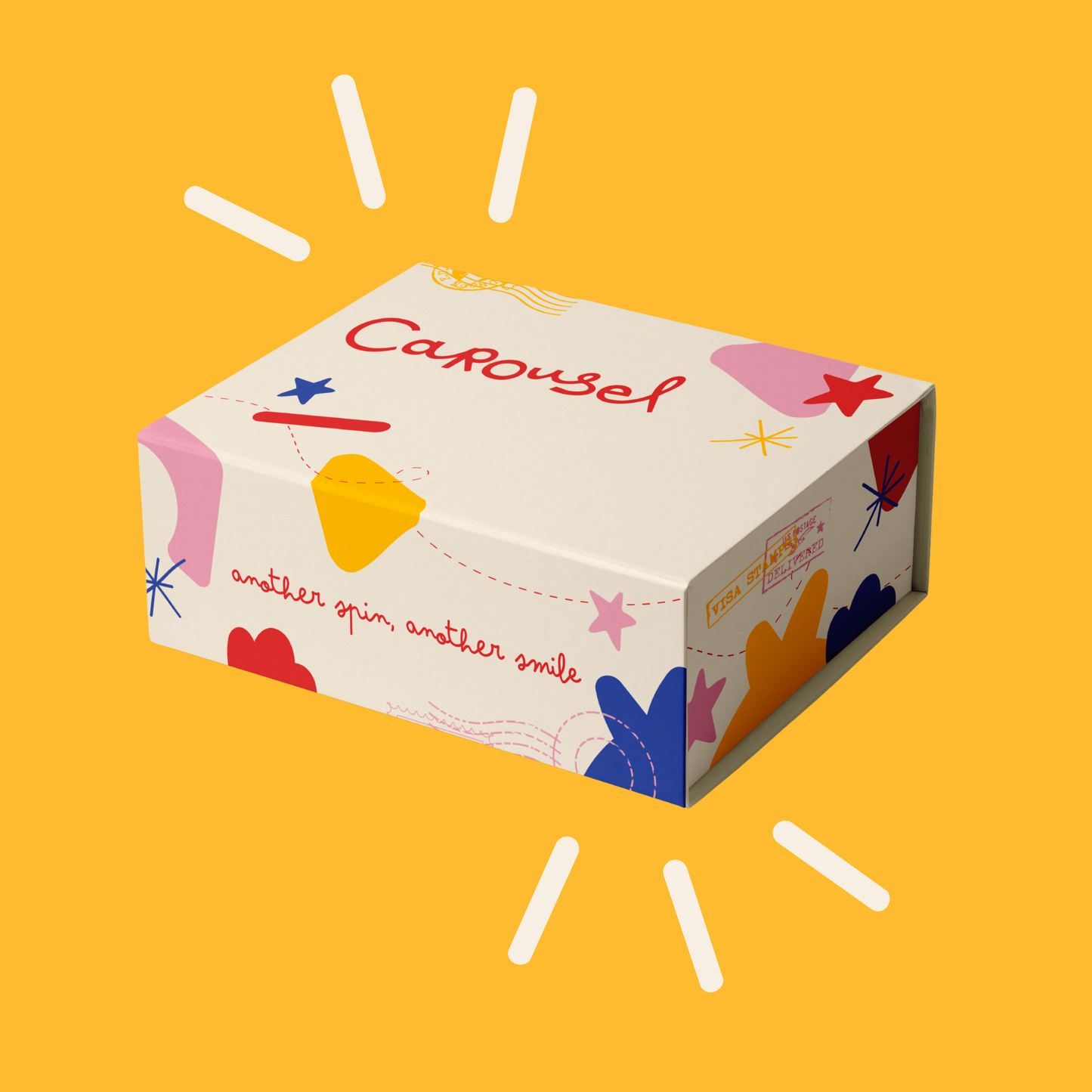 A rectangular product box with a cream-colored background and colorful abstract graphics, including the word 'Carousel' in red script and the phrase 'another spin, another smile' in red cursive. The box is shown on a solid yellow background with white sunburst lines.