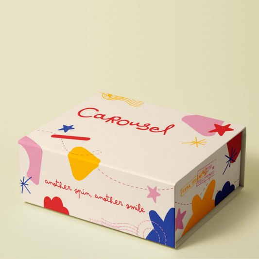 Colorful box with 'Carrousel' branding and abstract shapes on a light background