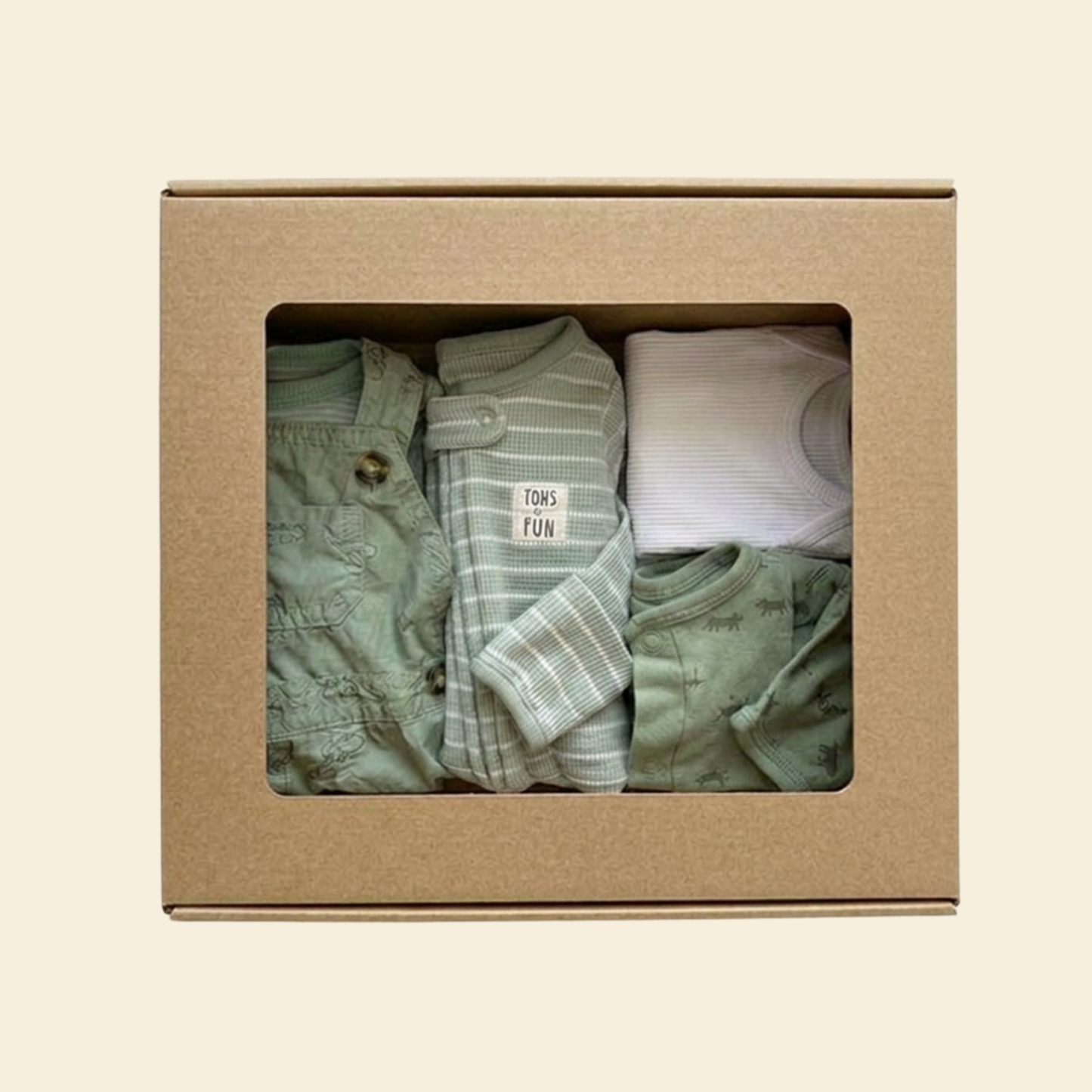 Picture of a kraft box of baby boy's clothes in green and white tones