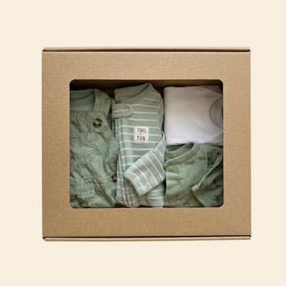 Picture of a kraft box of baby boy's clothes in green and white tones