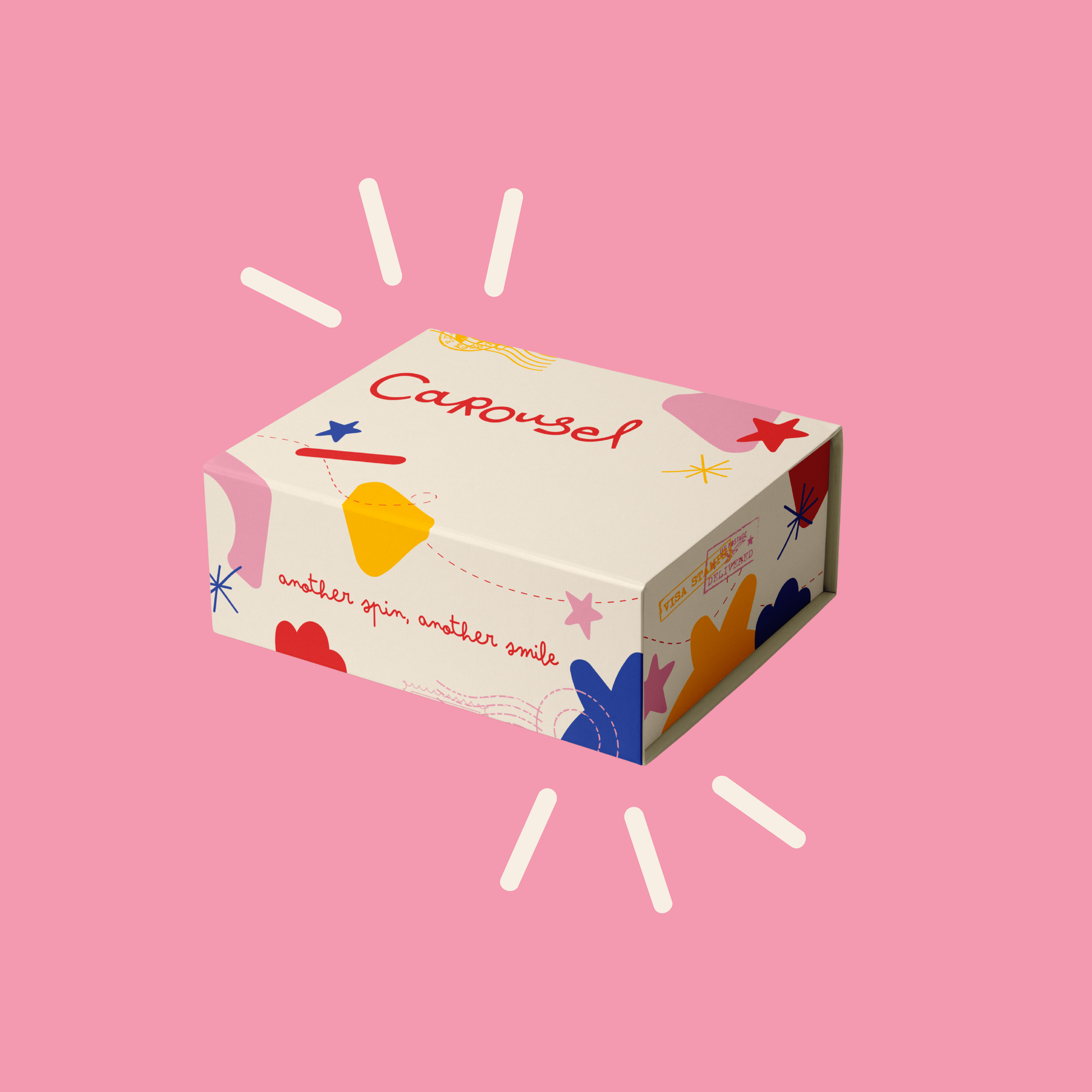 A decorative product box labeled 'Carousel' with colorful abstract shapes and script text, shown on a solid pink background with white light rays.